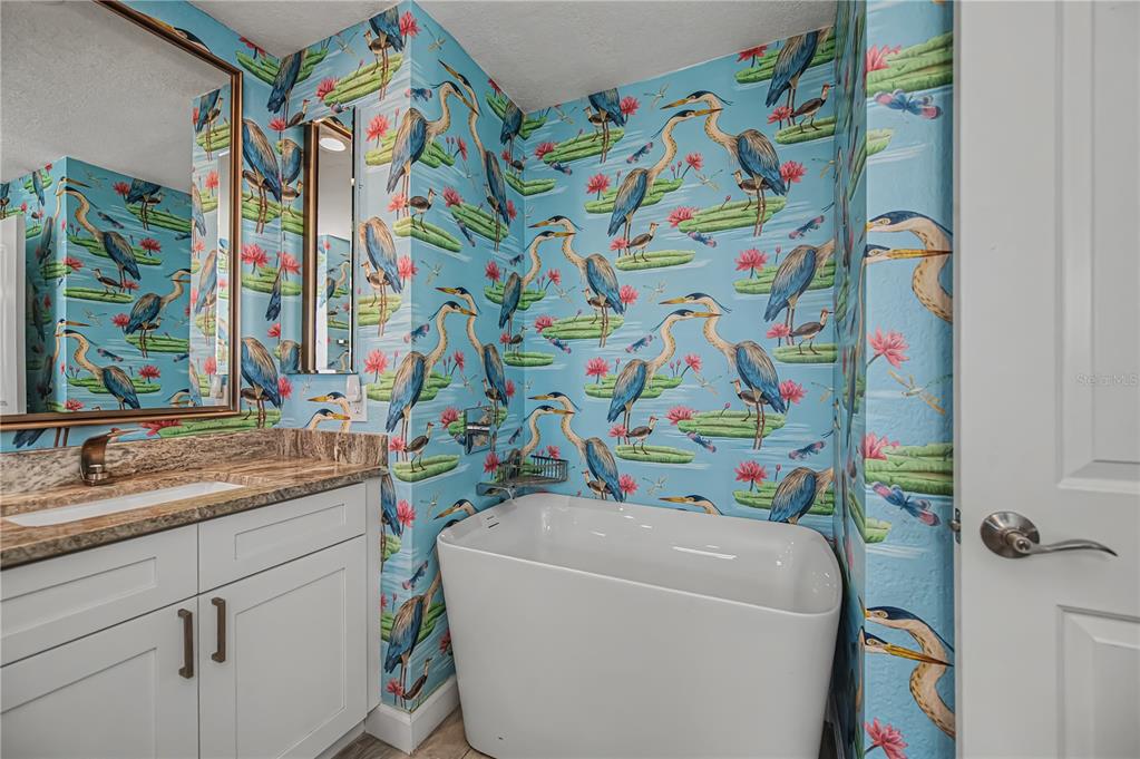 159 April Road Rotonda West, FL 33947 - Photo 35 of 73 a bathroom with a sink a toilet and a shower curtain