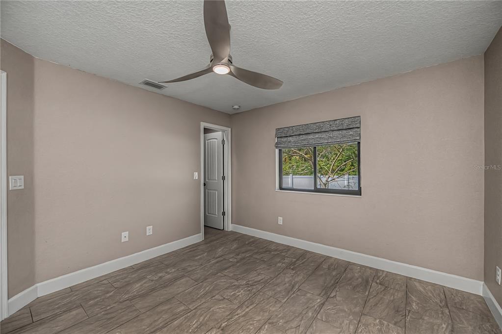 159 April Road Rotonda West, FL 33947 - Photo 39 of 73 wooden floor in an empty room with a window