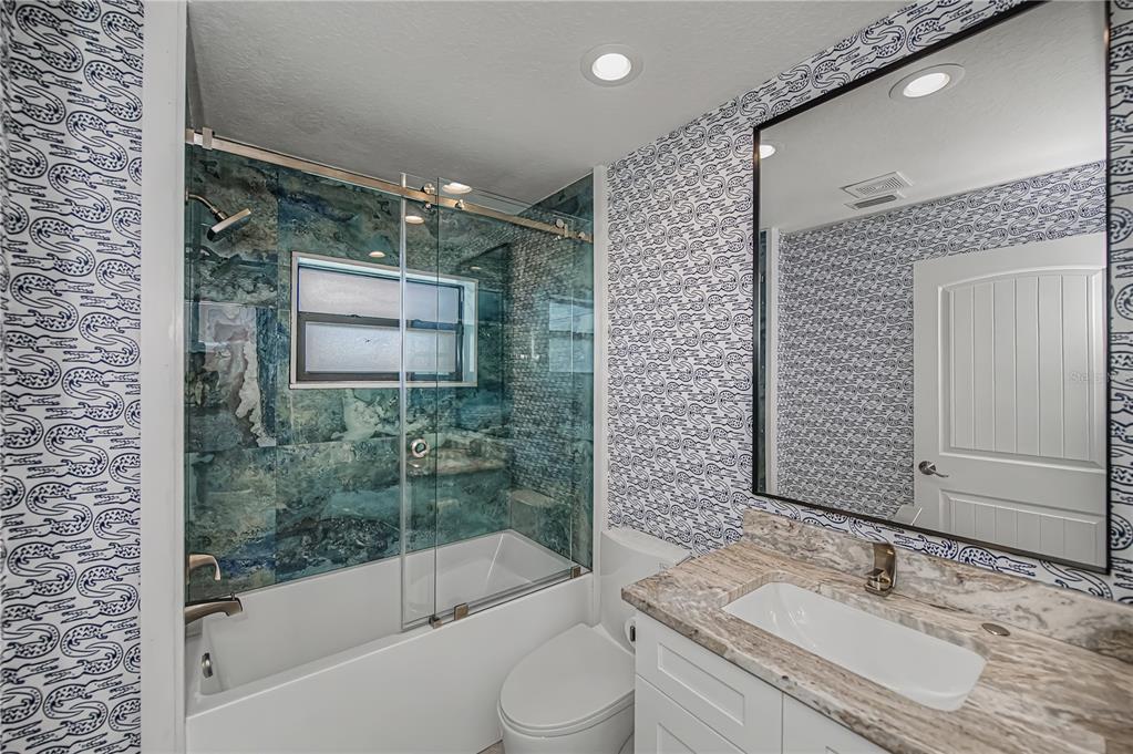 159 April Road Rotonda West, FL 33947 - Photo 43 of 73 a bathroom with a granite countertop sink toilet and shower