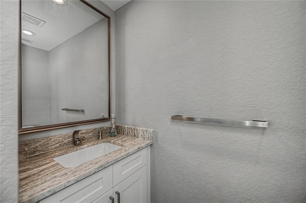 159 April Road Rotonda West, FL 33947 - Photo 52 of 73 a bathroom with a granite countertop sink and a mirror