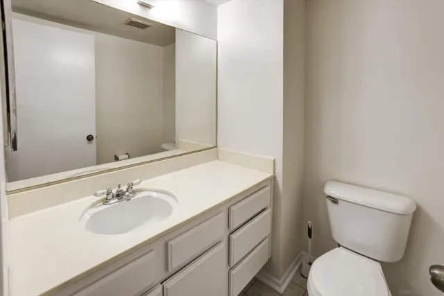 a bathroom with a sink toilet and a mirror