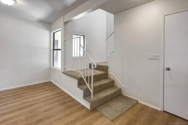a view of wooden floor and windows in a room