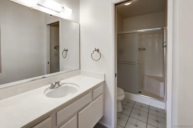 a bathroom with a shower and a toilet