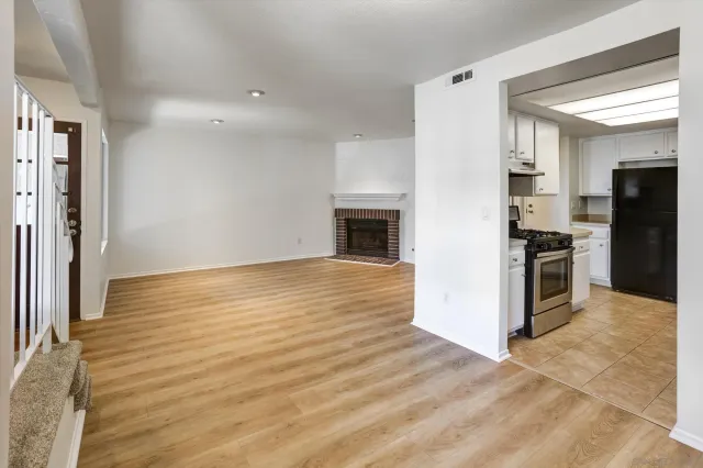 an empty room with kitchen appliances and cabinets