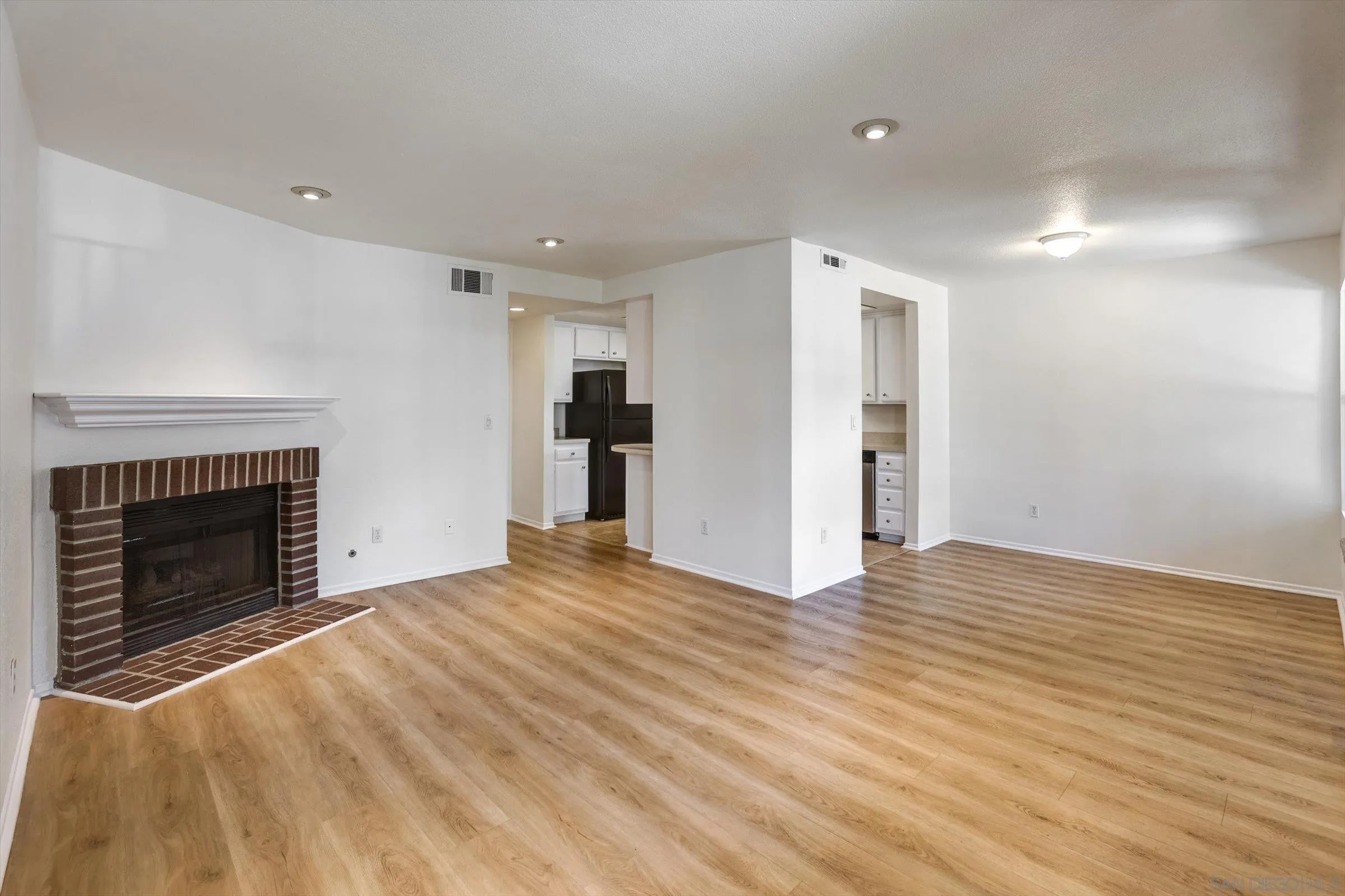 13230 Johannesberg Way, Unit 10 Poway, CA 92064 - Photo 6 of 40 a view of an empty room with wooden floor fireplace and a window