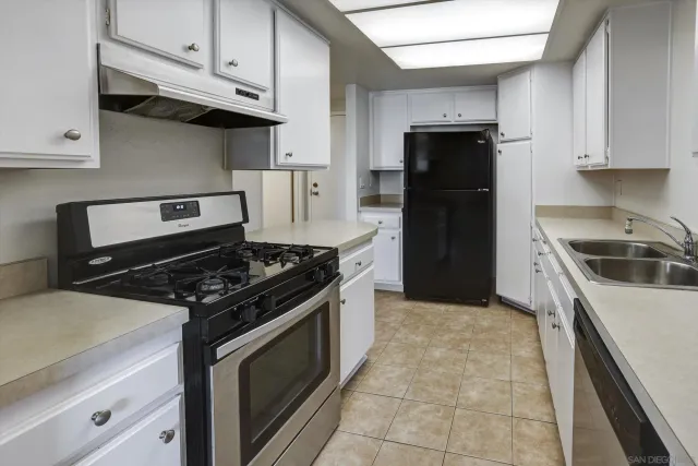 a kitchen with stainless steel appliances granite countertop a stove and a refrigerator