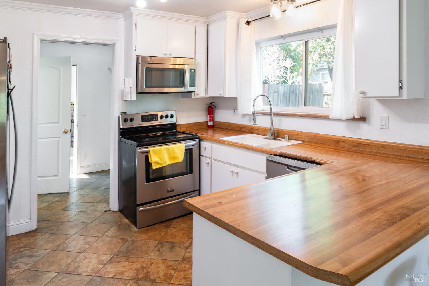 32 Boxelder Court Napa, CA 94558 - Photo 16 of 75 a kitchen with stainless steel appliances granite countertop a sink and a microwave