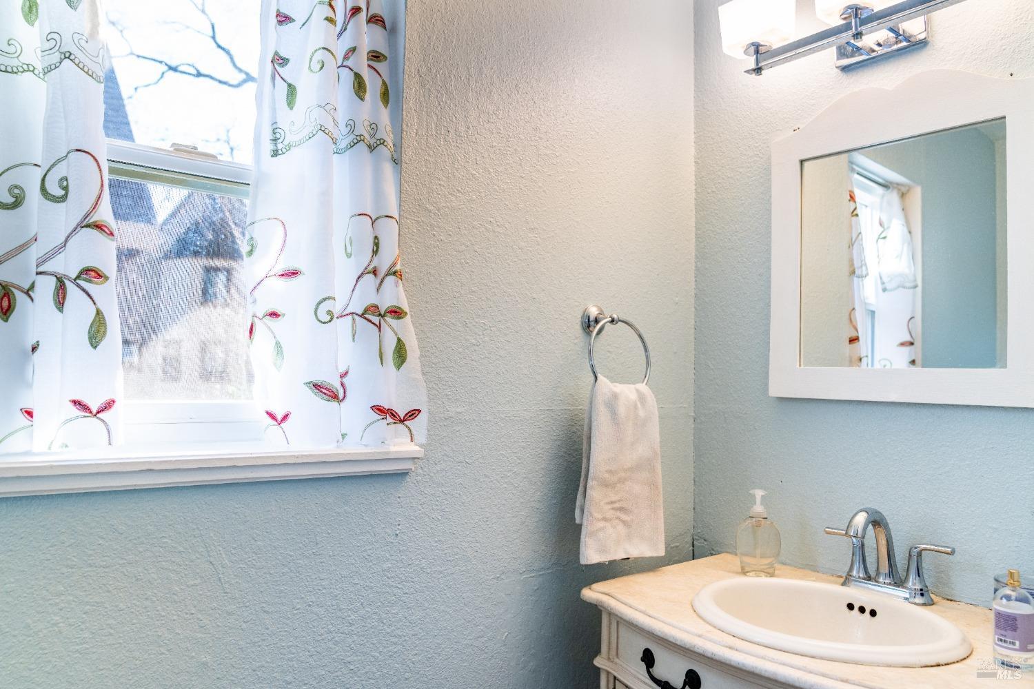 32 Boxelder Court Napa, CA 94558 - Photo 19 of 75 a bathroom with a sink mirror and vanity
