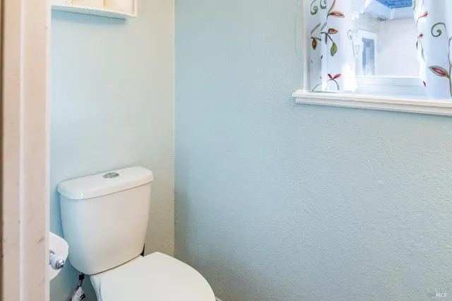 a living room with furniture and a lamp