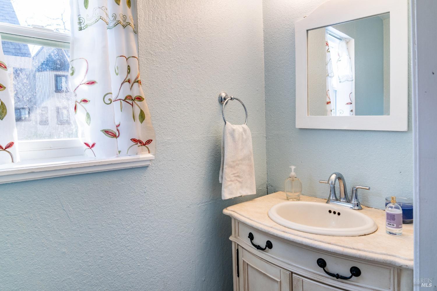 32 Boxelder Court Napa, CA 94558 - Photo 22 of 75 a bathroom with a sink and a mirror