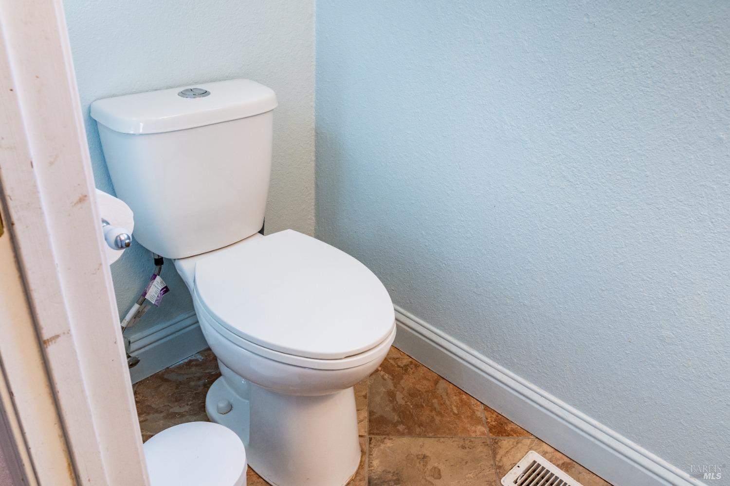 32 Boxelder Court Napa, CA 94558 - Photo 23 of 75 a white toilet sitting next to a small sink