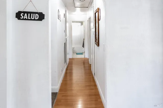 a bathroom with a granite countertop sink a mirror and a shower curtain