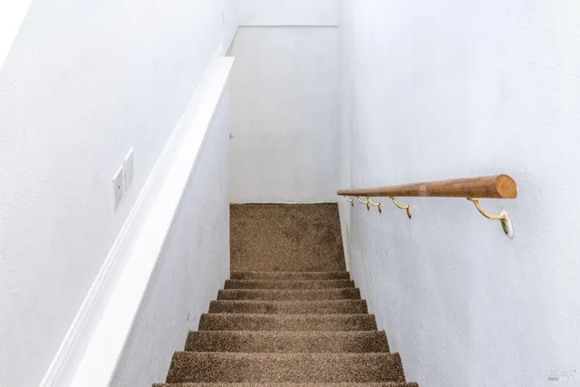 a white toilet sitting next to a small bathroom