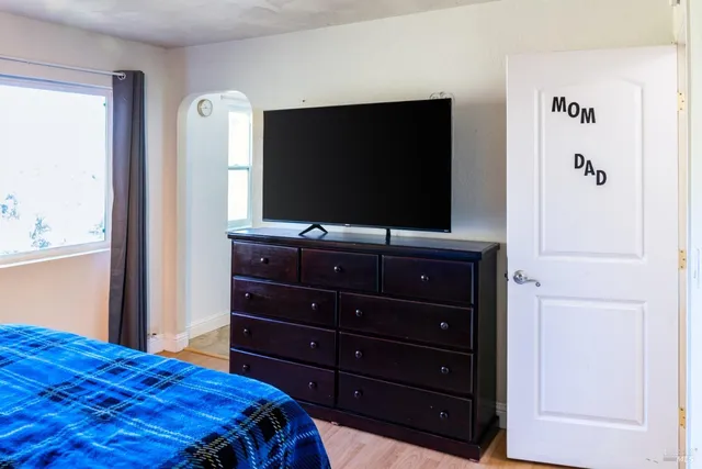 a bedroom with a bed and a dresser