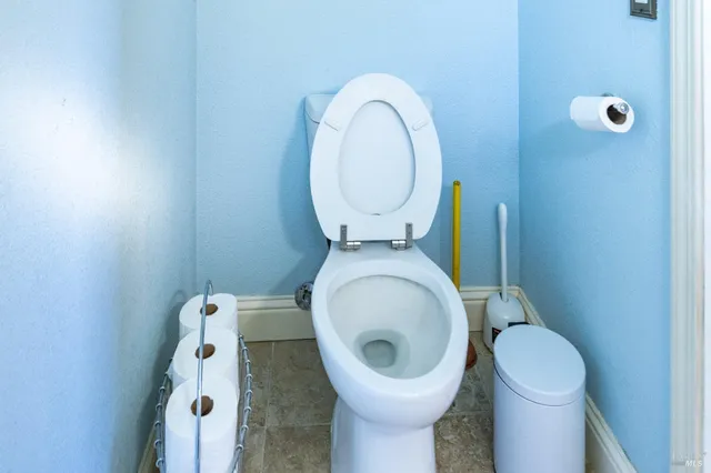 a kitchen with stainless steel appliances kitchen island granite countertop a sink and a refrigerator