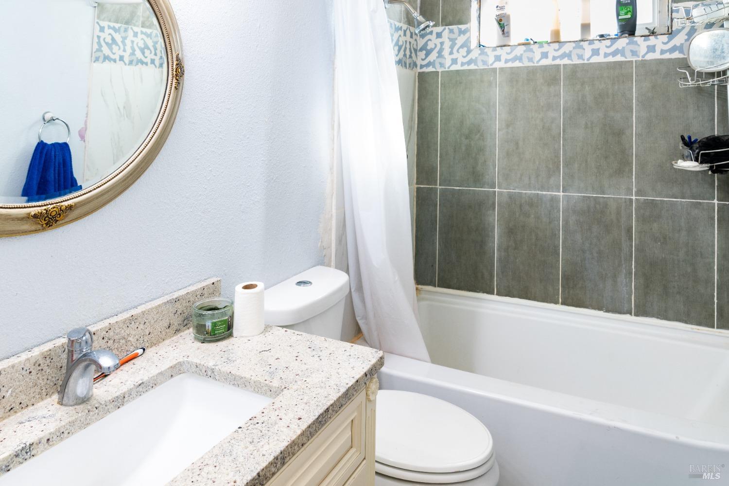32 Boxelder Court Napa, CA 94558 - Photo 50 of 75 a bathroom with a granite countertop sink a toilet and bathtub