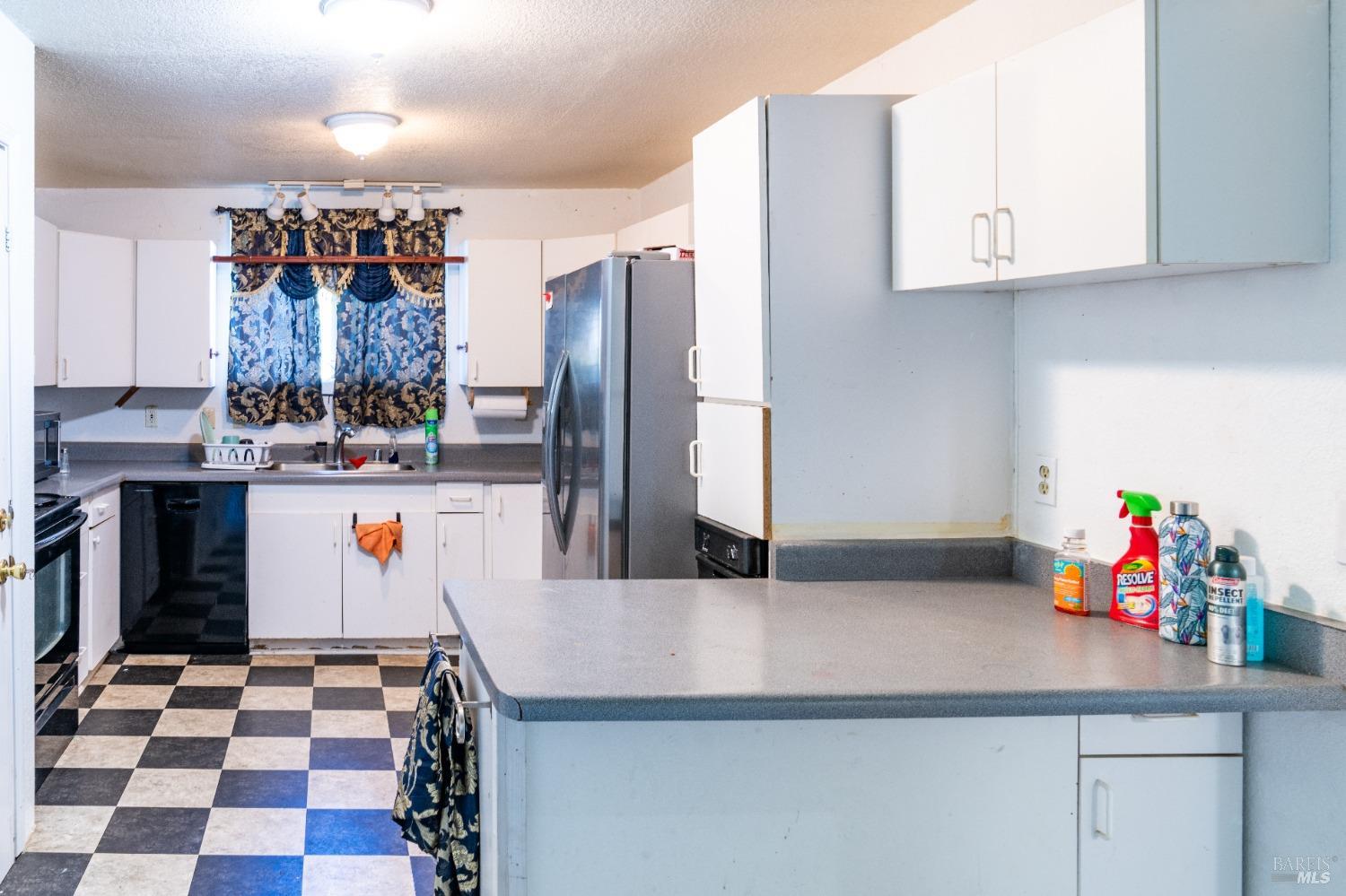 32 Boxelder Court Napa, CA 94558 - Photo 70 of 75 a kitchen with stainless steel appliances kitchen island granite countertop a sink and a refrigerator