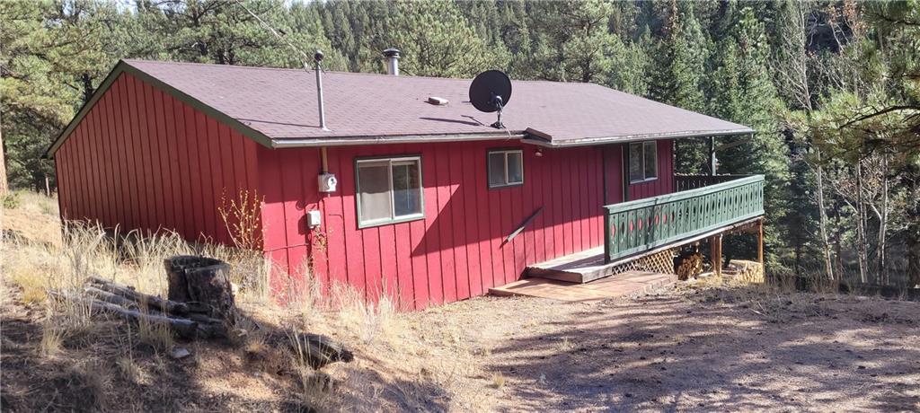 1428 South Crystal Road Lake George, CO 80827 - Photo 3 of 35 a view of a house with a yard wooden fence and a large tree