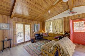 1428 South Crystal Road Lake George, CO 80827 - Photo 8 of 35 a spacious bedroom with a bed and glass windows