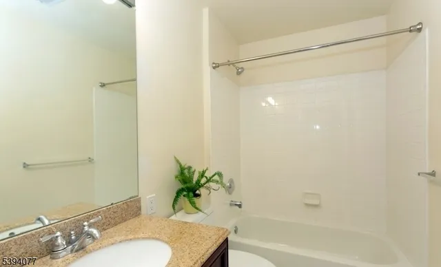 a bathroom with a granite countertop shower and a sink