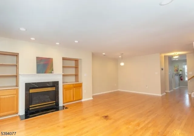 a view of an empty room with a fireplace
