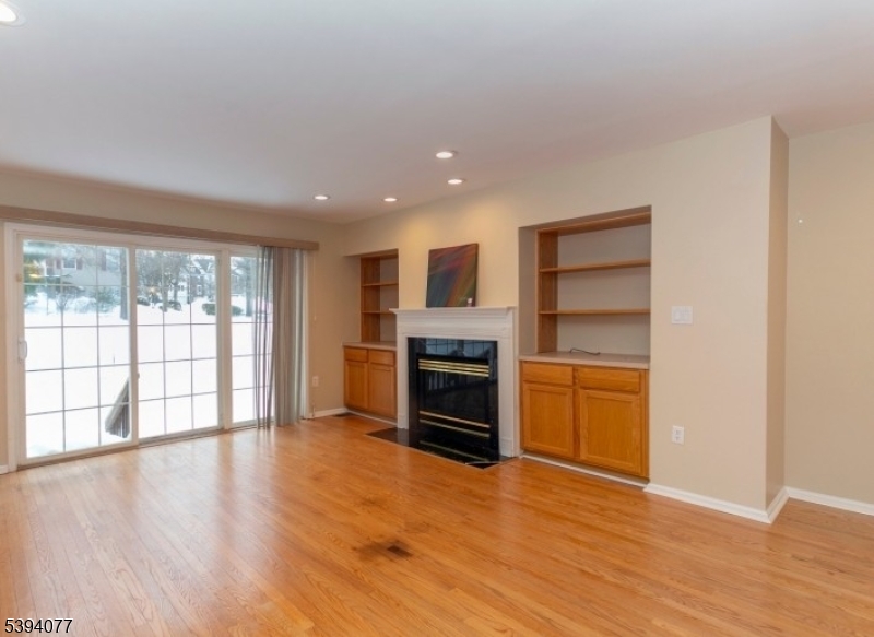 3 Minuteman Court Bernards, NJ 07920 - Photo 6 of 12 a view of a big room with wooden floor fire place and windows
