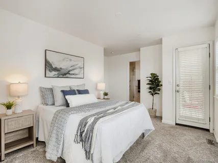 a spacious bedroom with a bed and a cabinets