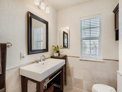 a bathroom with a sink a toilet and a mirror