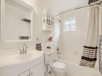 a bathroom with a sink toilet a shower and a mirror