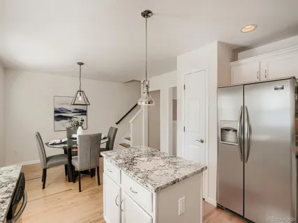 a kitchen with kitchen island a counter top space appliances and cabinets