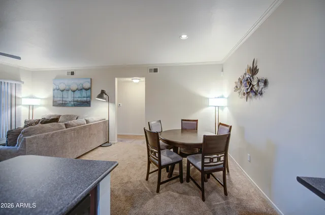 a large kitchen with a table and chairs
