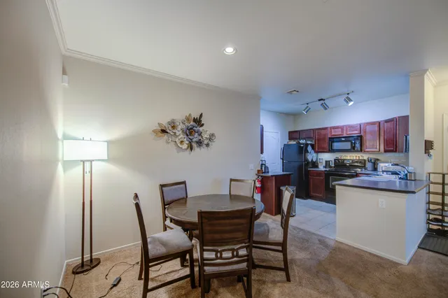 a dining room with furniture and window