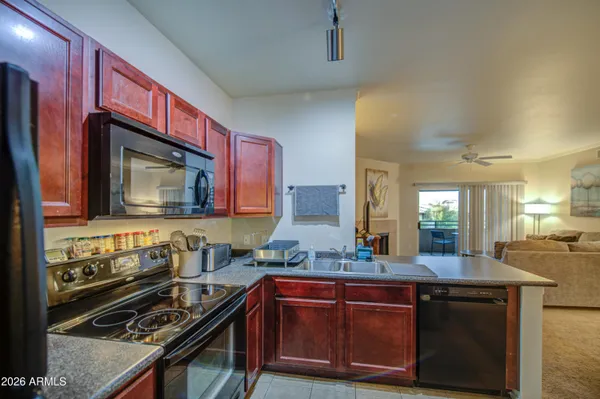 a kitchen with wooden cabinets and a stove top oven