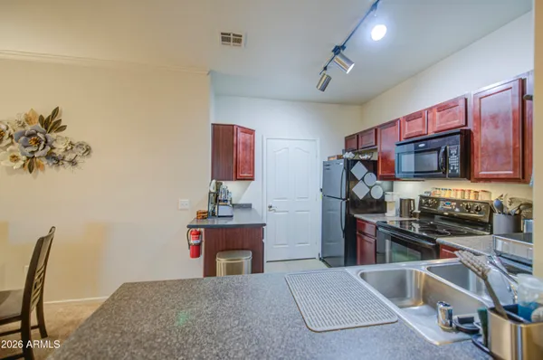 a kitchen with stainless steel appliances granite countertop a refrigerator and a stove top oven