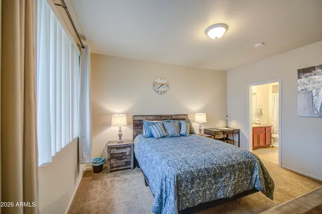a living room with a couch and a dresser next to a window