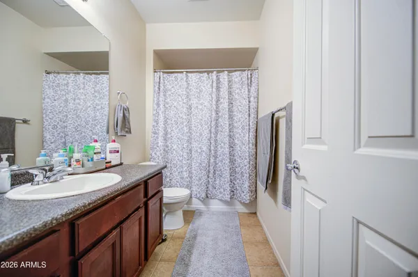 a bathroom with a double vanity sink toilet and a mirror