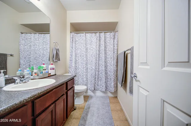 a bathroom with a double vanity sink toilet and a mirror