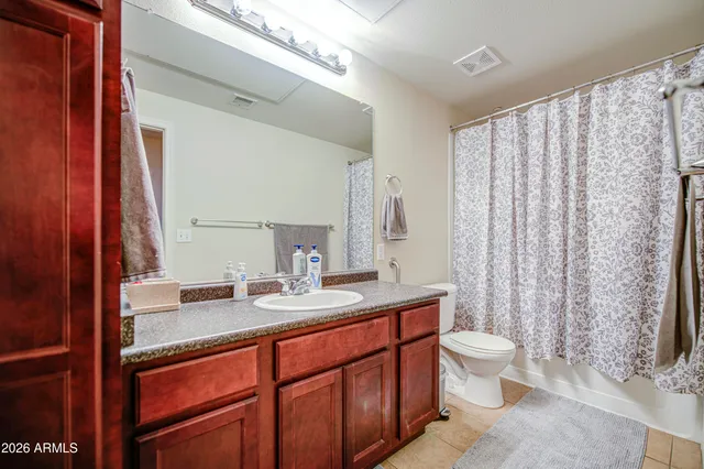 a bathroom with a sink vanity mirror and toilet
