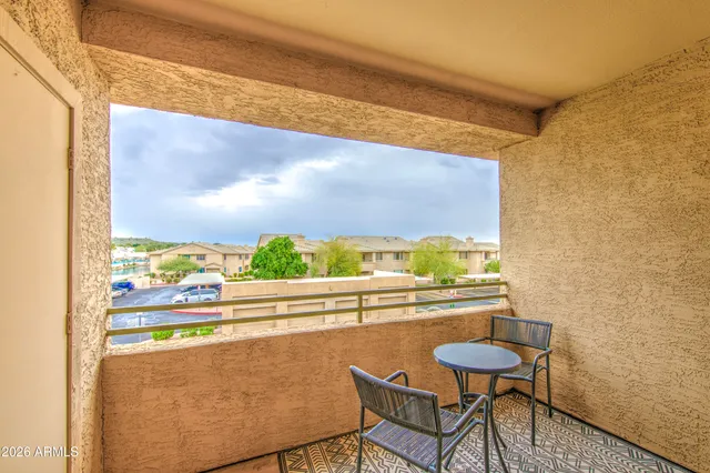 a view of a balcony with an outdoor seating
