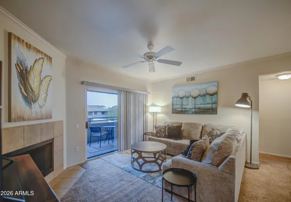 a living room with furniture and a fireplace