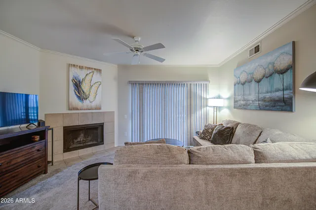 a living room with furniture and a fireplace
