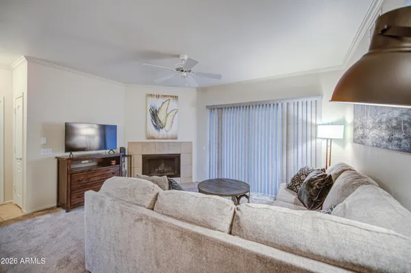 a living room with furniture a fireplace and a flat screen tv
