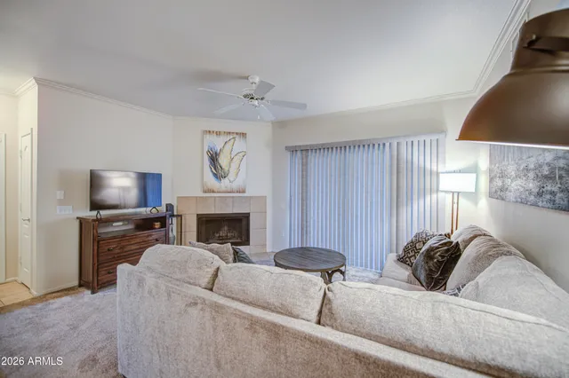 a living room with furniture a fireplace and a flat screen tv