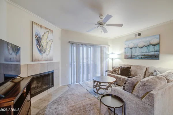 a living room with furniture and a fireplace