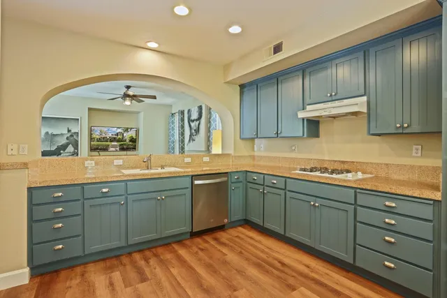 a spacious bathroom with a granite countertop sink and a mirror