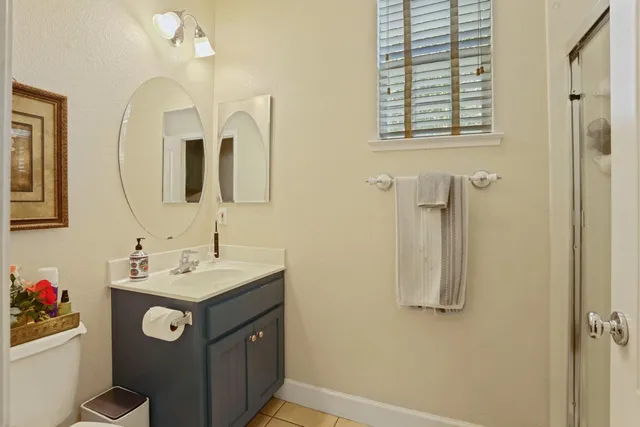 a bathroom with a sink vanity and a mirror
