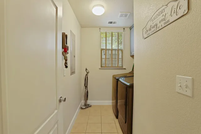 a view of hallway with a window and a refrigerator