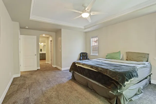 a bedroom with a bed and a chandelier