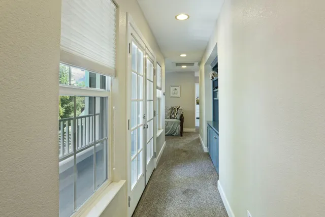 a view of a hallway with a view of a bathroom