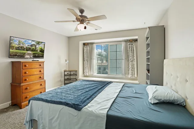 a bedroom with a bed and a dresser in it